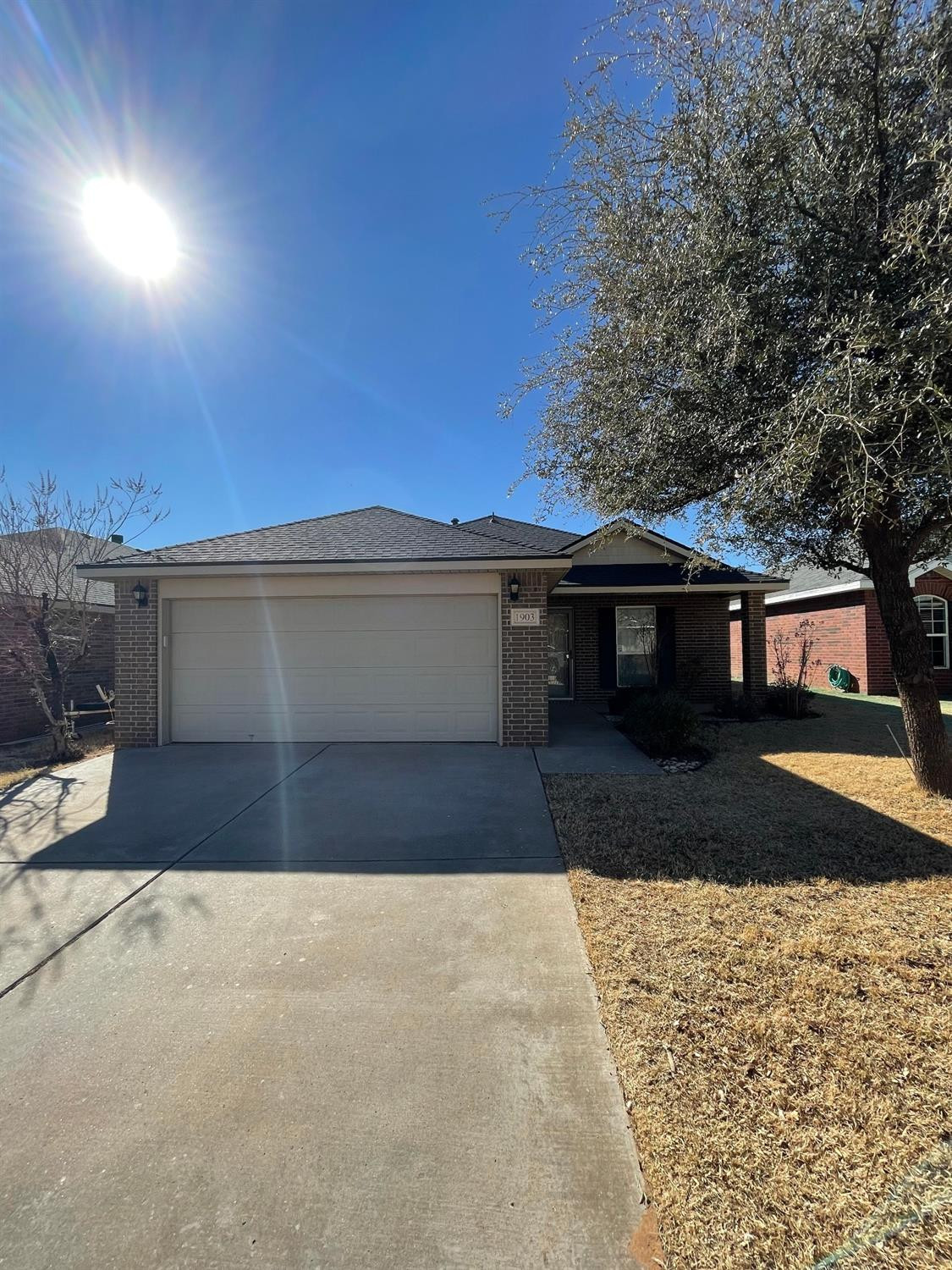 1903 99th Place Lubbock, TX 79423 - Photo 1 of 10 a front view of a house with a yard and garage