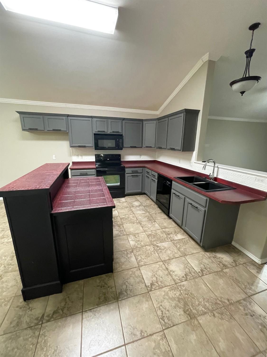1903 99th Place Lubbock, TX 79423 - Photo 3 of 10 a kitchen with stainless steel appliances kitchen island granite countertop a sink and cabinets