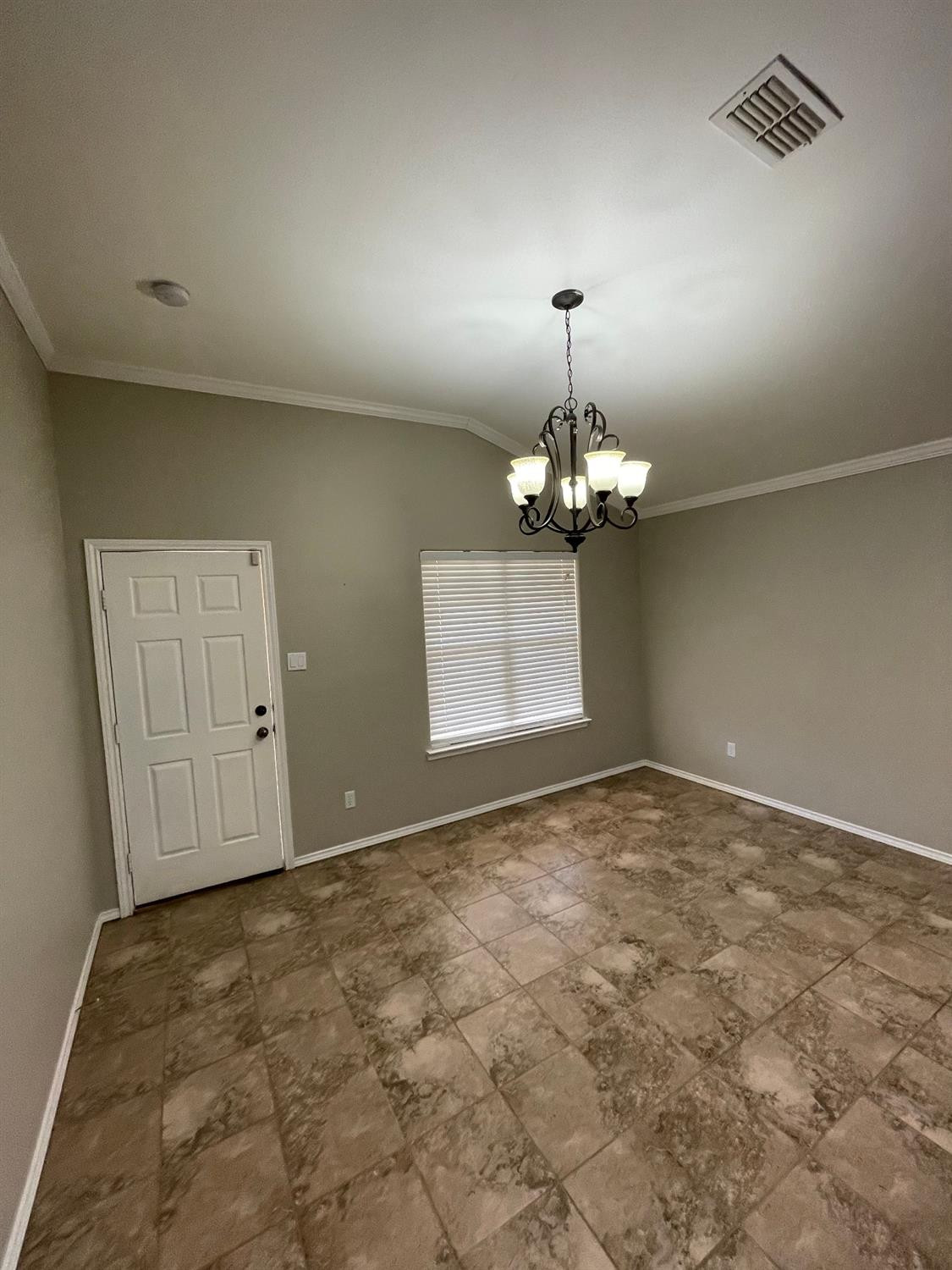 1903 99th Place Lubbock, TX 79423 - Photo 4 of 10 a view of an empty room with chandelier fan and wooden floor