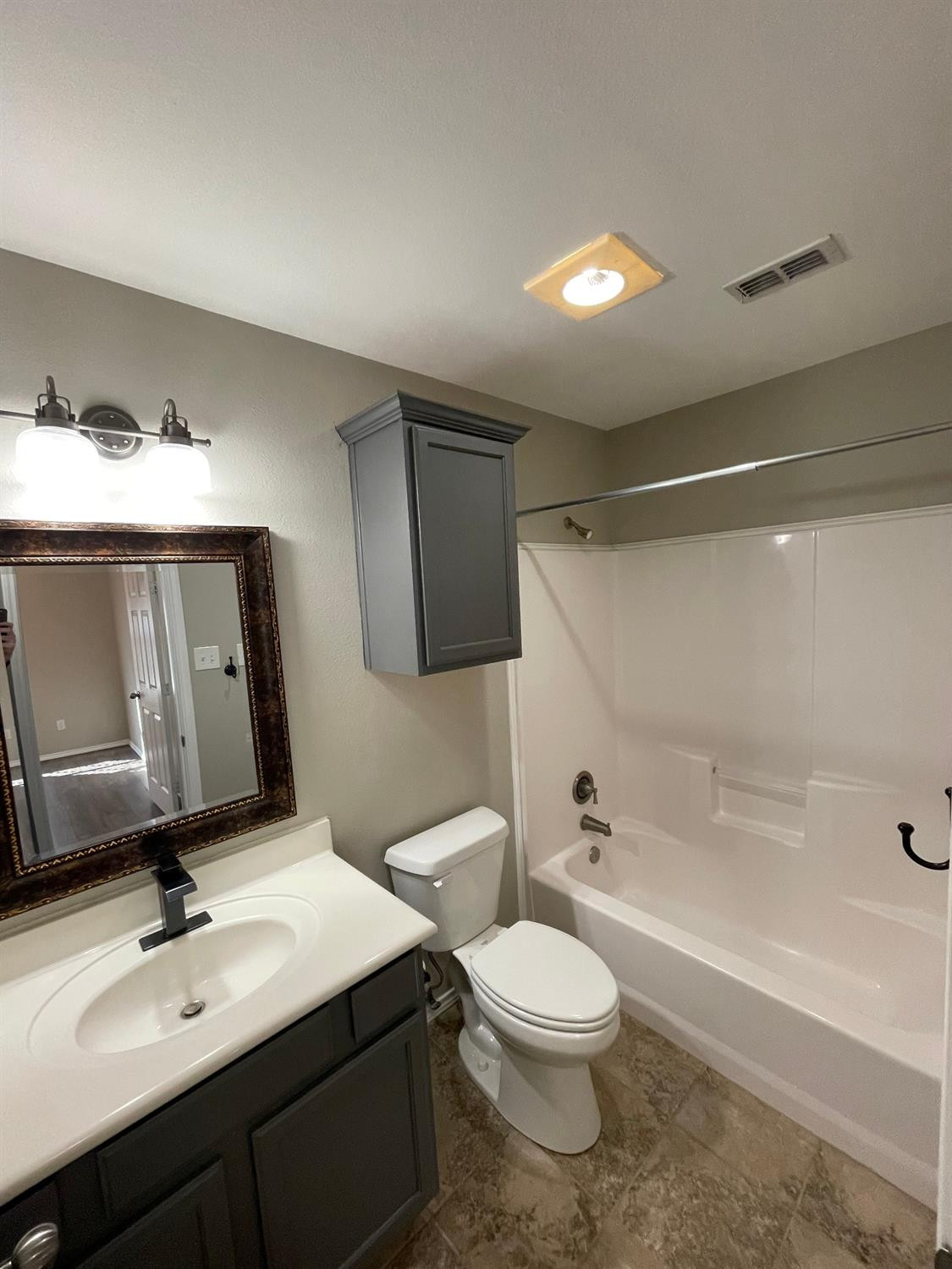 1903 99th Place Lubbock, TX 79423 - Photo 6 of 10 a bathroom with a toilet sink and mirror