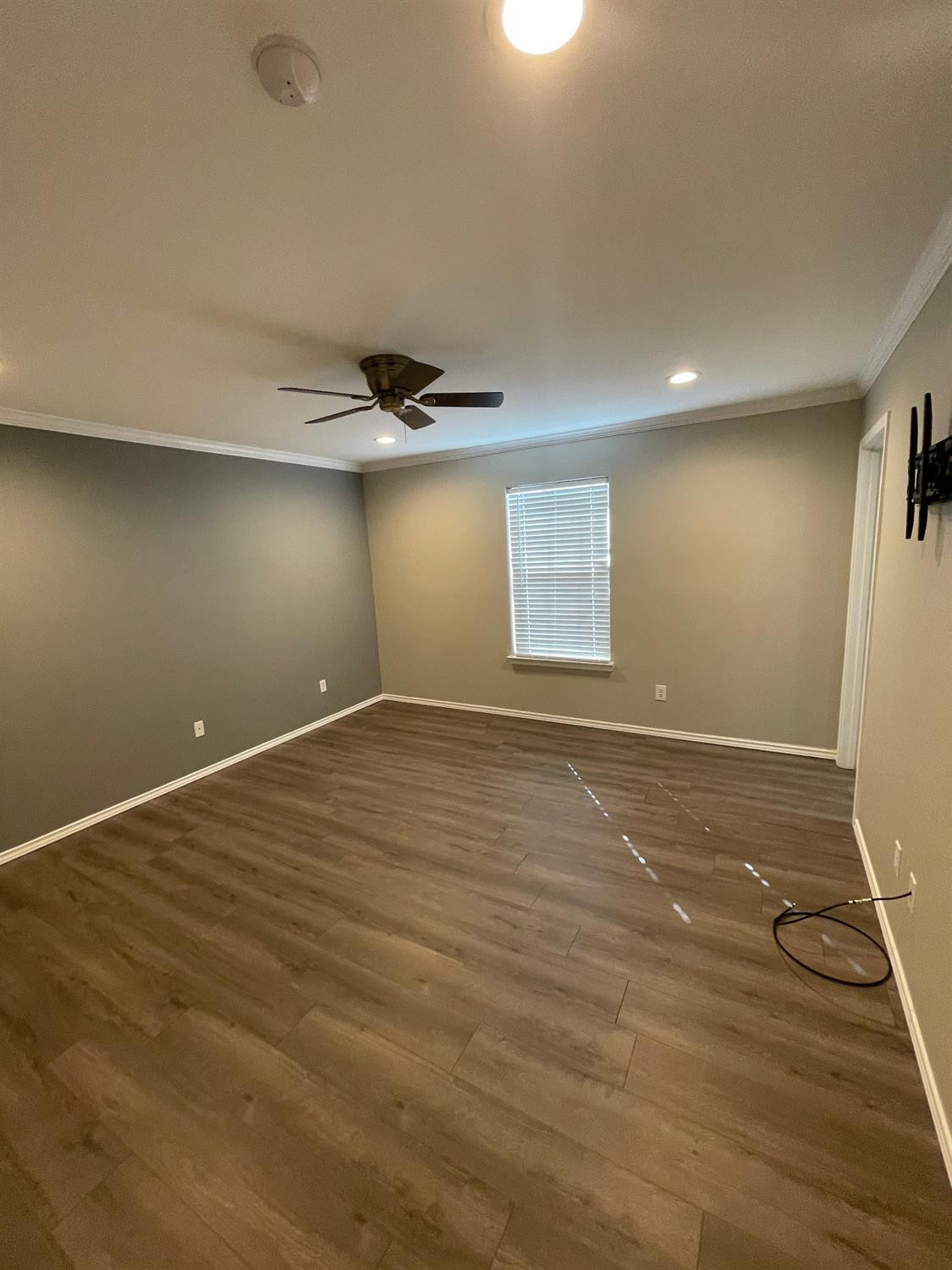 1903 99th Place Lubbock, TX 79423 - Photo 9 of 10 an empty room with wooden floor and windows