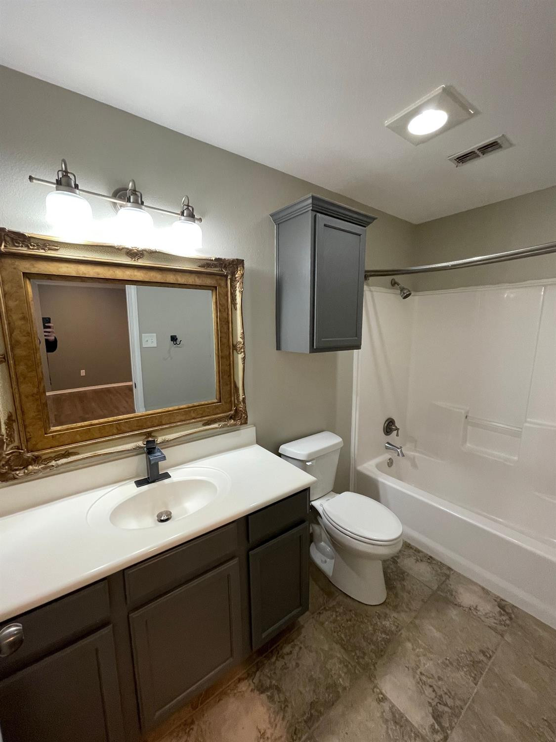 1903 99th Place Lubbock, TX 79423 - Photo 10 of 10 a bathroom with a sink vanity mirror bathtub and toilet