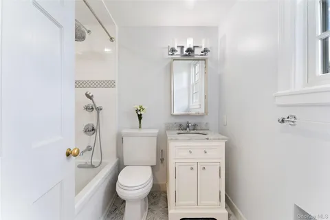 a white toilet sitting next to a bathroom sink