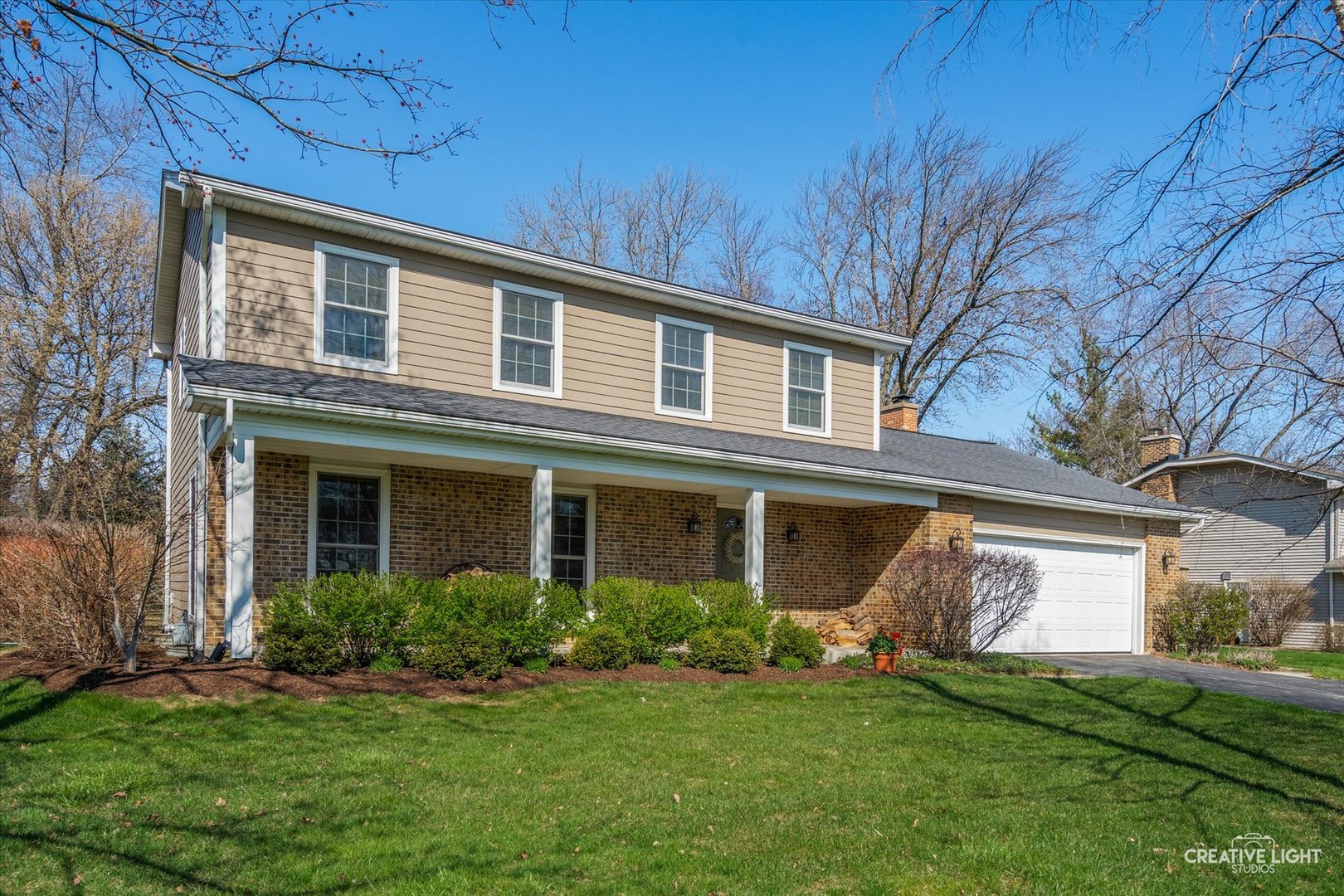 a front view of a house with a garden