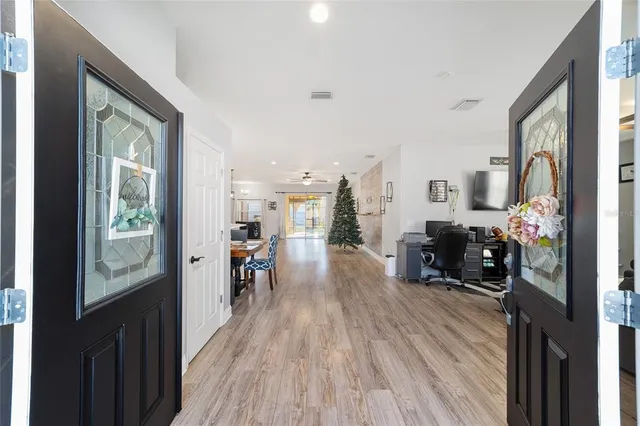 an empty room with a ceiling fan and window