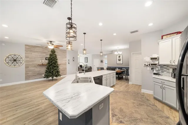 a view of a room with wooden floor and windows