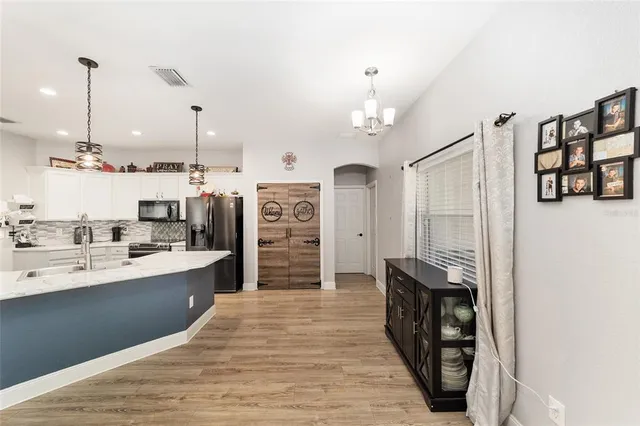 a view of a house with pool and sitting area