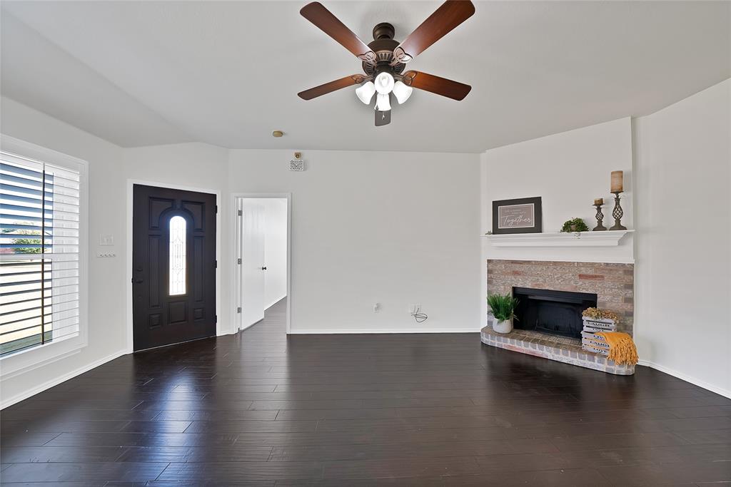 308 South Chestnut Street Forney, TX 75126 - Photo 13 of 25 a living room with fireplace and wooden floor