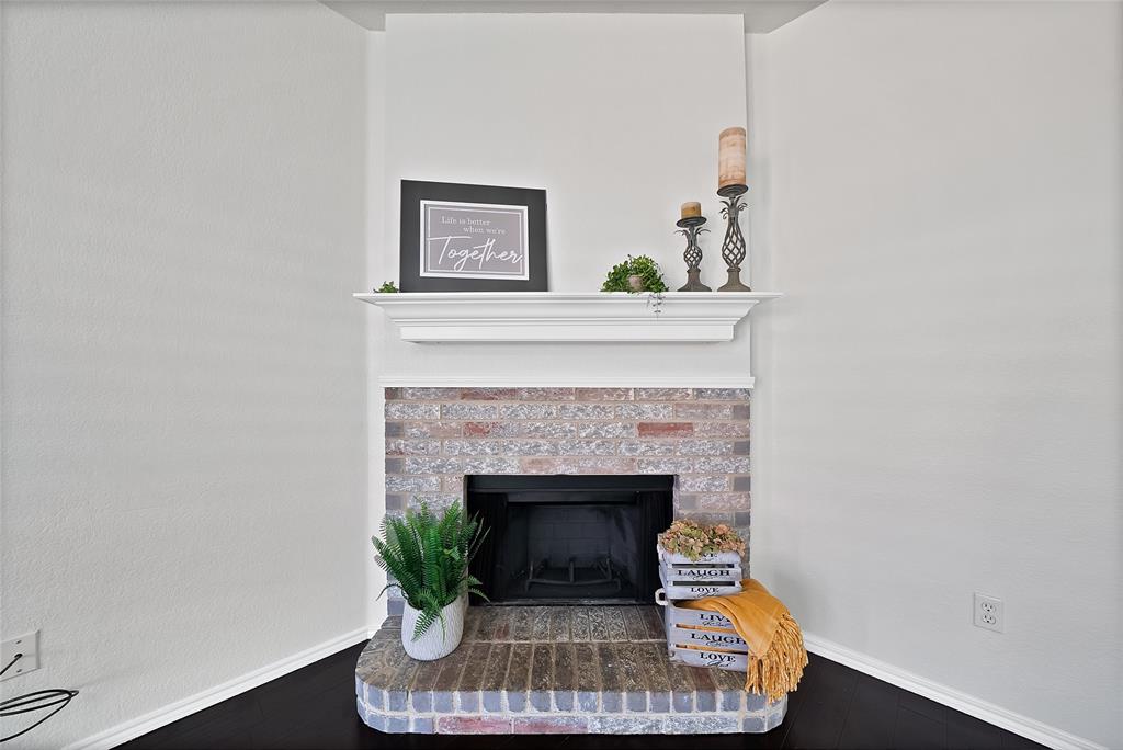 308 South Chestnut Street Forney, TX 75126 - Photo 2 of 25 a living room with a fireplace and a potted plant