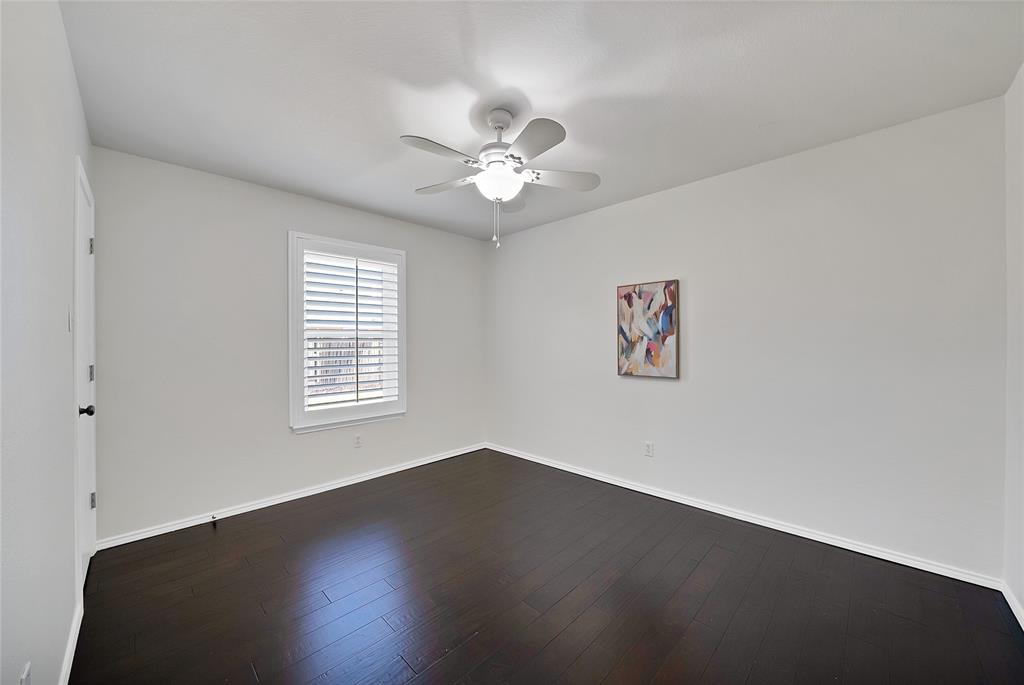 308 South Chestnut Street Forney, TX 75126 - Photo 23 of 25 an empty room with a window and a ceiling fan