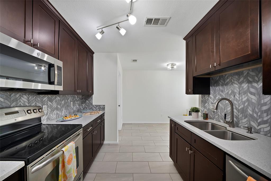 308 South Chestnut Street Forney, TX 75126 - Photo 7 of 25 a kitchen with a sink stove and microwave