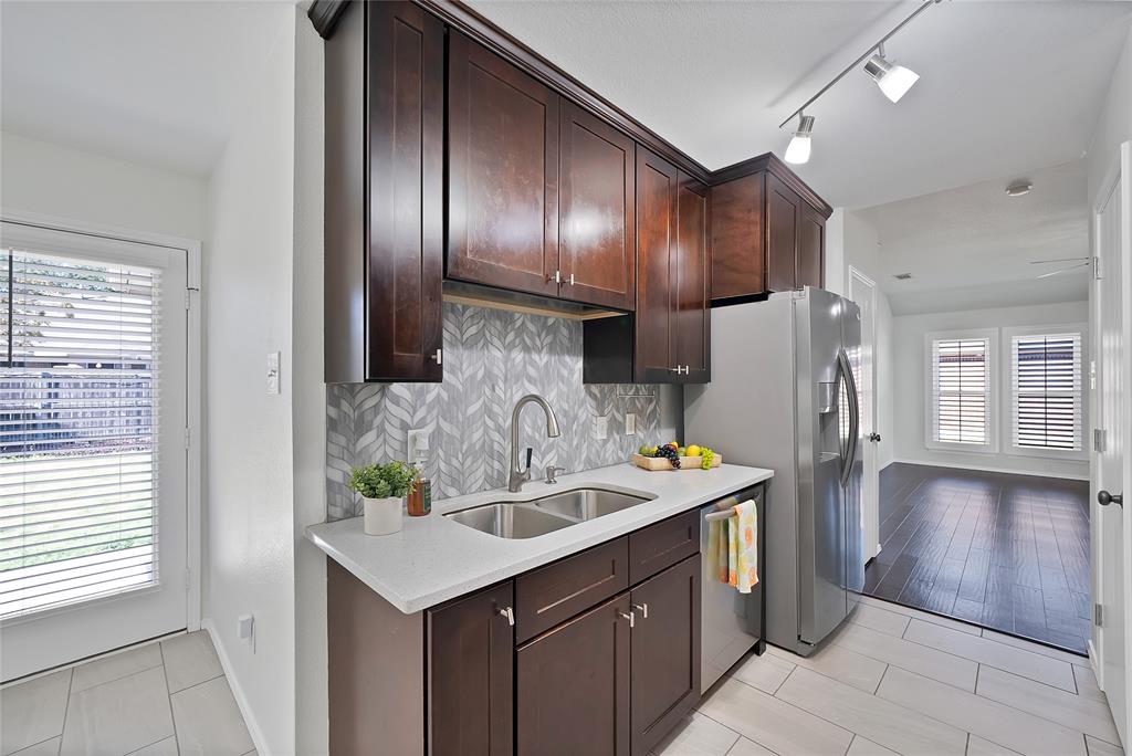308 South Chestnut Street Forney, TX 75126 - Photo 8 of 25 a kitchen with granite countertop stainless steel appliances a sink stove and refrigerator