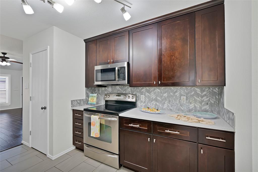 308 South Chestnut Street Forney, TX 75126 - Photo 9 of 25 a kitchen with a sink stove and microwave