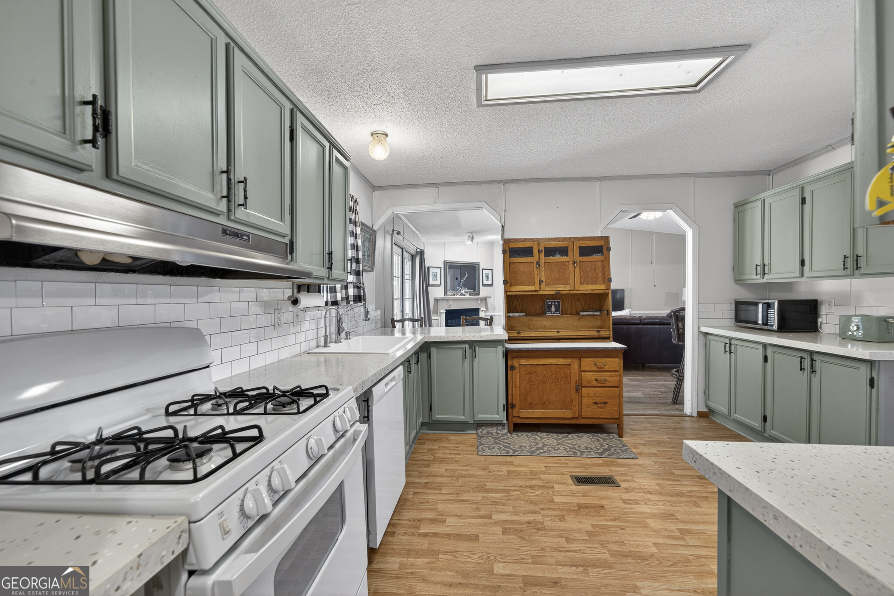 392 Hub Dent Road Northeast Milledgeville, GA 31061 - Photo 14 of 66 a kitchen with stainless steel appliances granite countertop a stove and a sink
