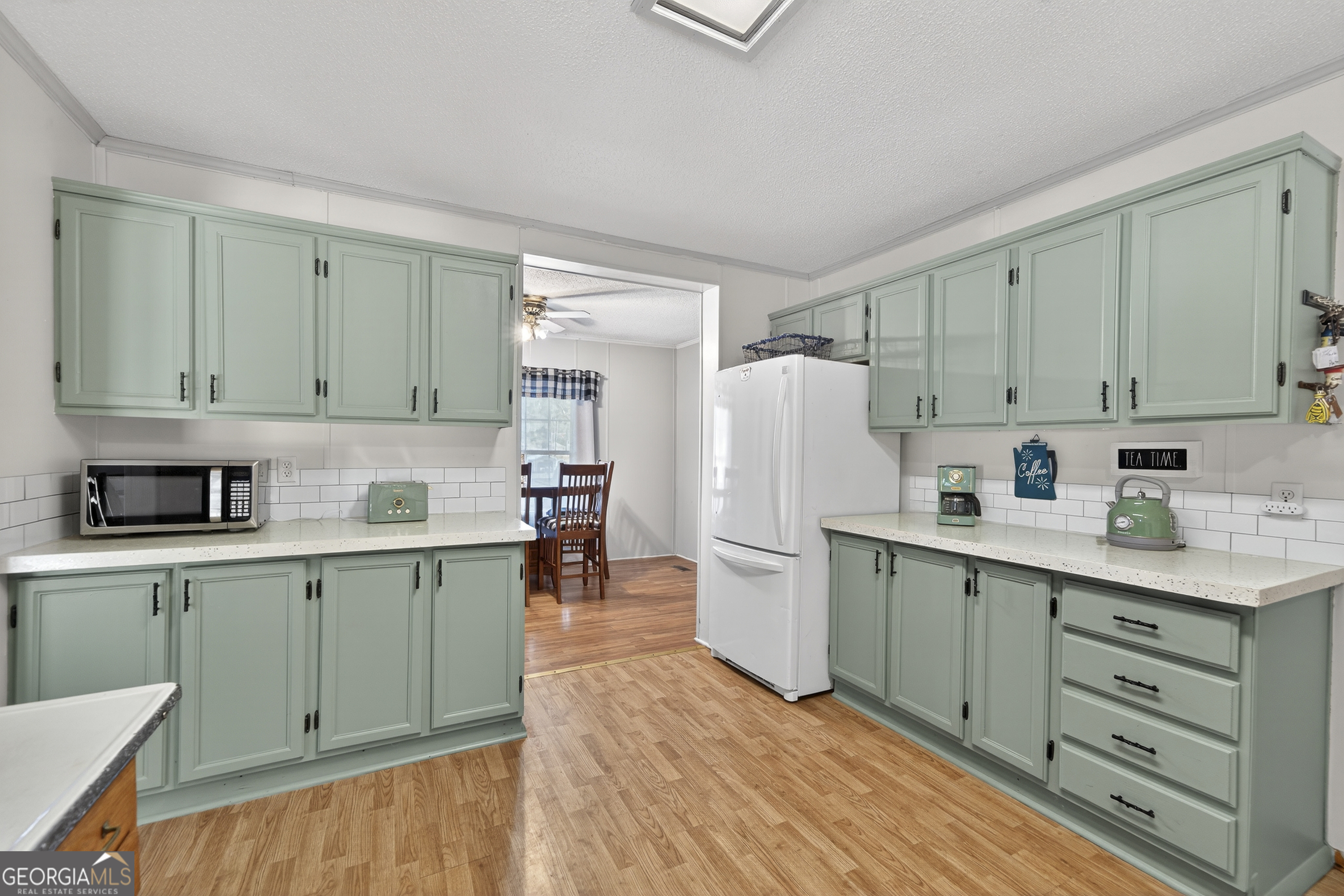 392 Hub Dent Road Northeast Milledgeville, GA 31061 - Photo 16 of 66 a kitchen with refrigerator and cabinets
