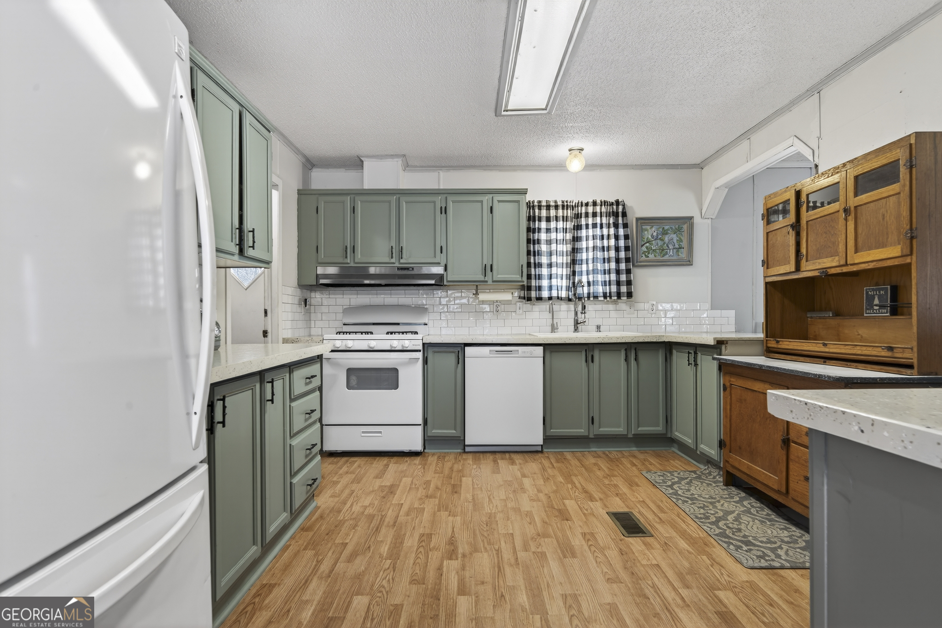 392 Hub Dent Road Northeast Milledgeville, GA 31061 - Photo 17 of 66 a kitchen with stainless steel appliances granite countertop a stove a sink and a refrigerator