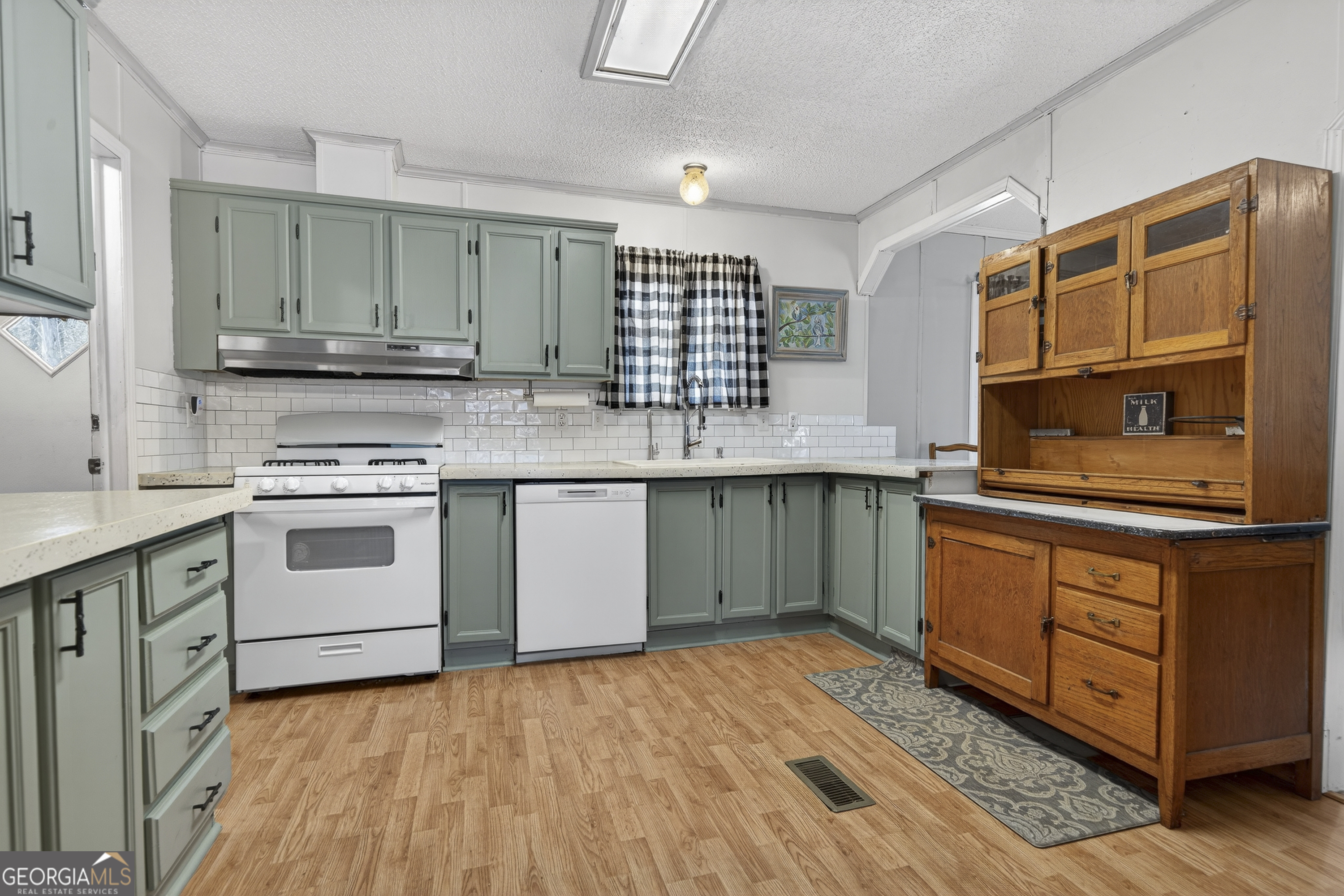 392 Hub Dent Road Northeast Milledgeville, GA 31061 - Photo 18 of 66 a kitchen with stainless steel appliances granite countertop a stove a sink and a microwave