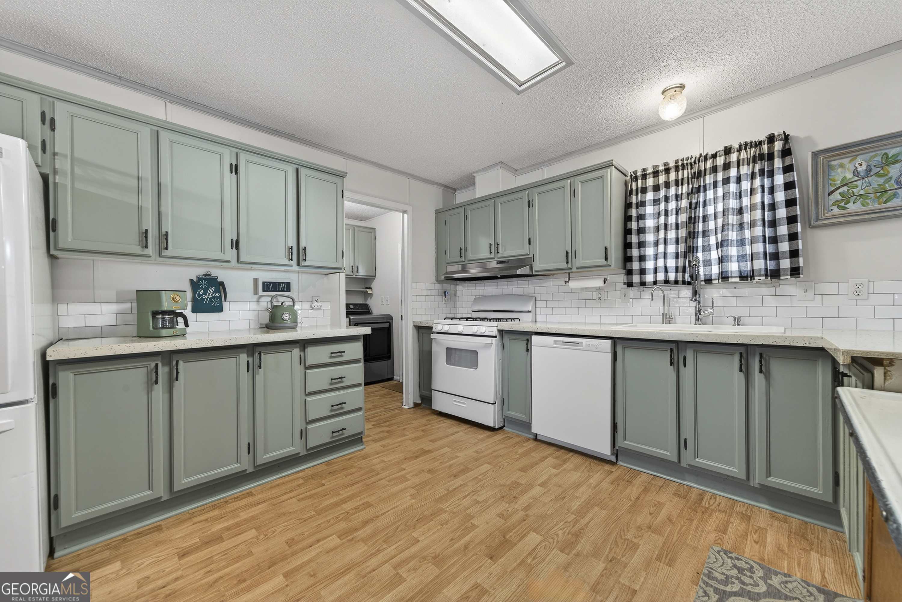 392 Hub Dent Road Northeast Milledgeville, GA 31061 - Photo 21 of 66 a kitchen with a sink cabinets and window