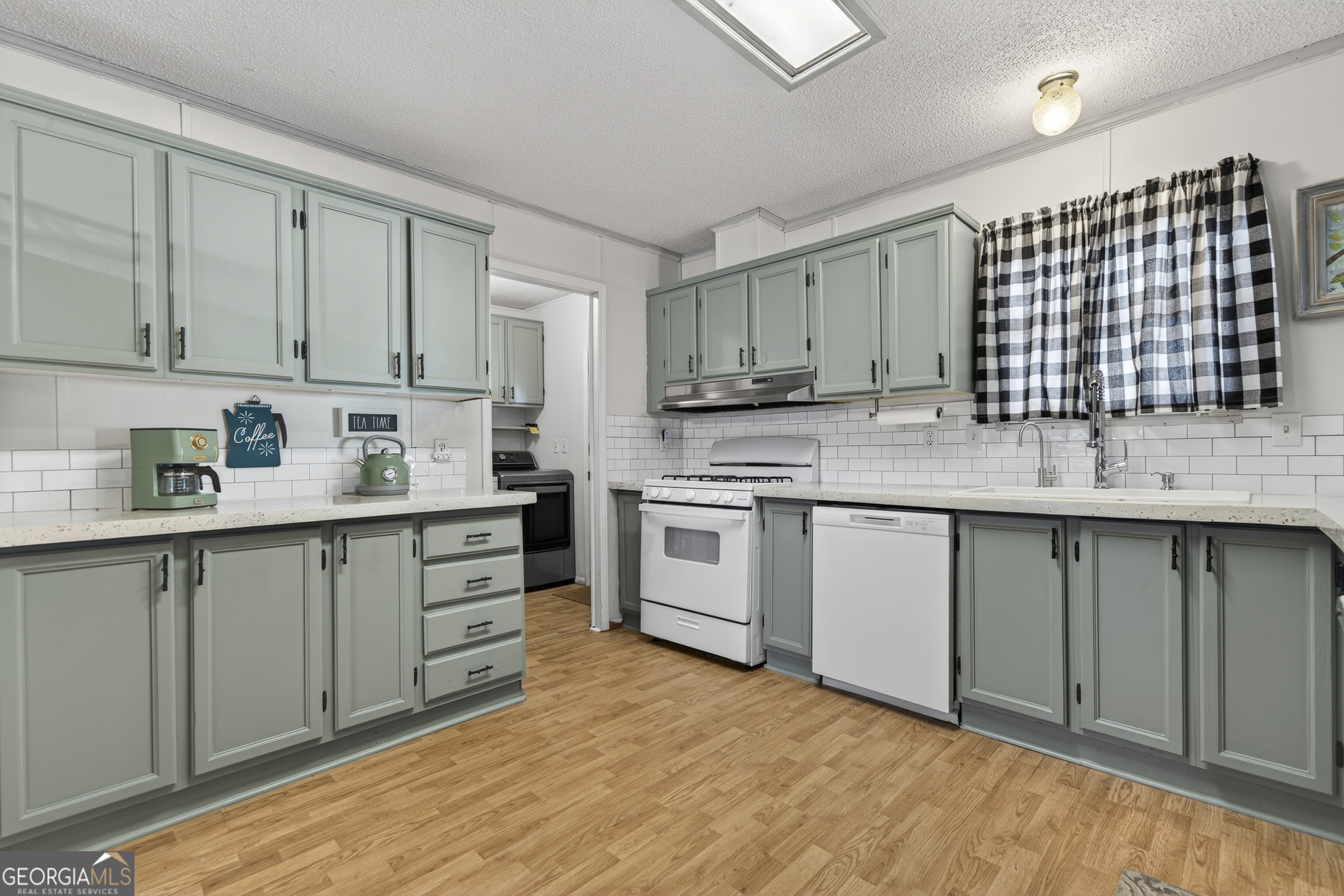 392 Hub Dent Road Northeast Milledgeville, GA 31061 - Photo 22 of 66 a kitchen with a sink cabinets stainless steel appliances and a window