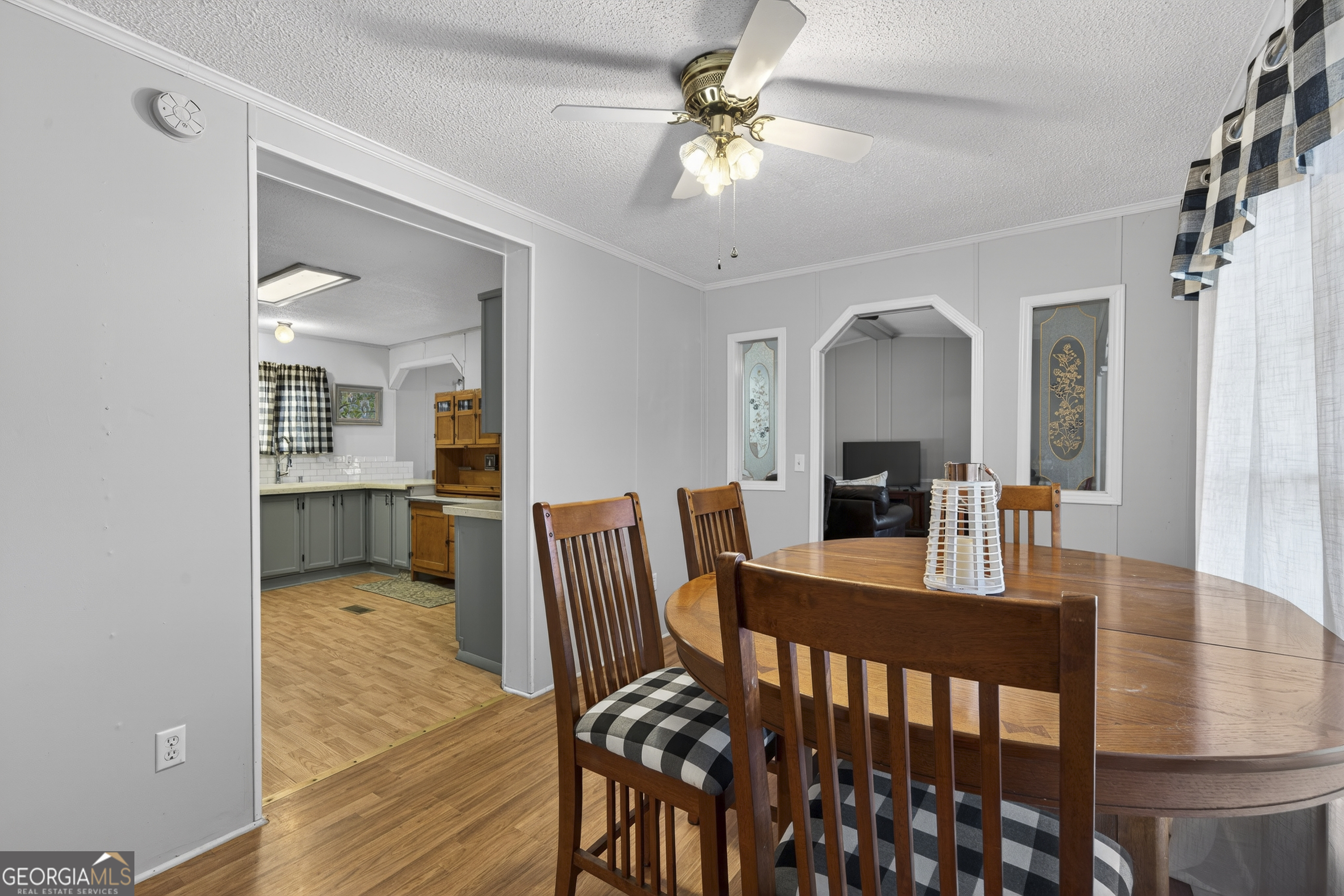 392 Hub Dent Road Northeast Milledgeville, GA 31061 - Photo 25 of 66 a view of a dining room and livingroom with furniture wooden floor a chandelier