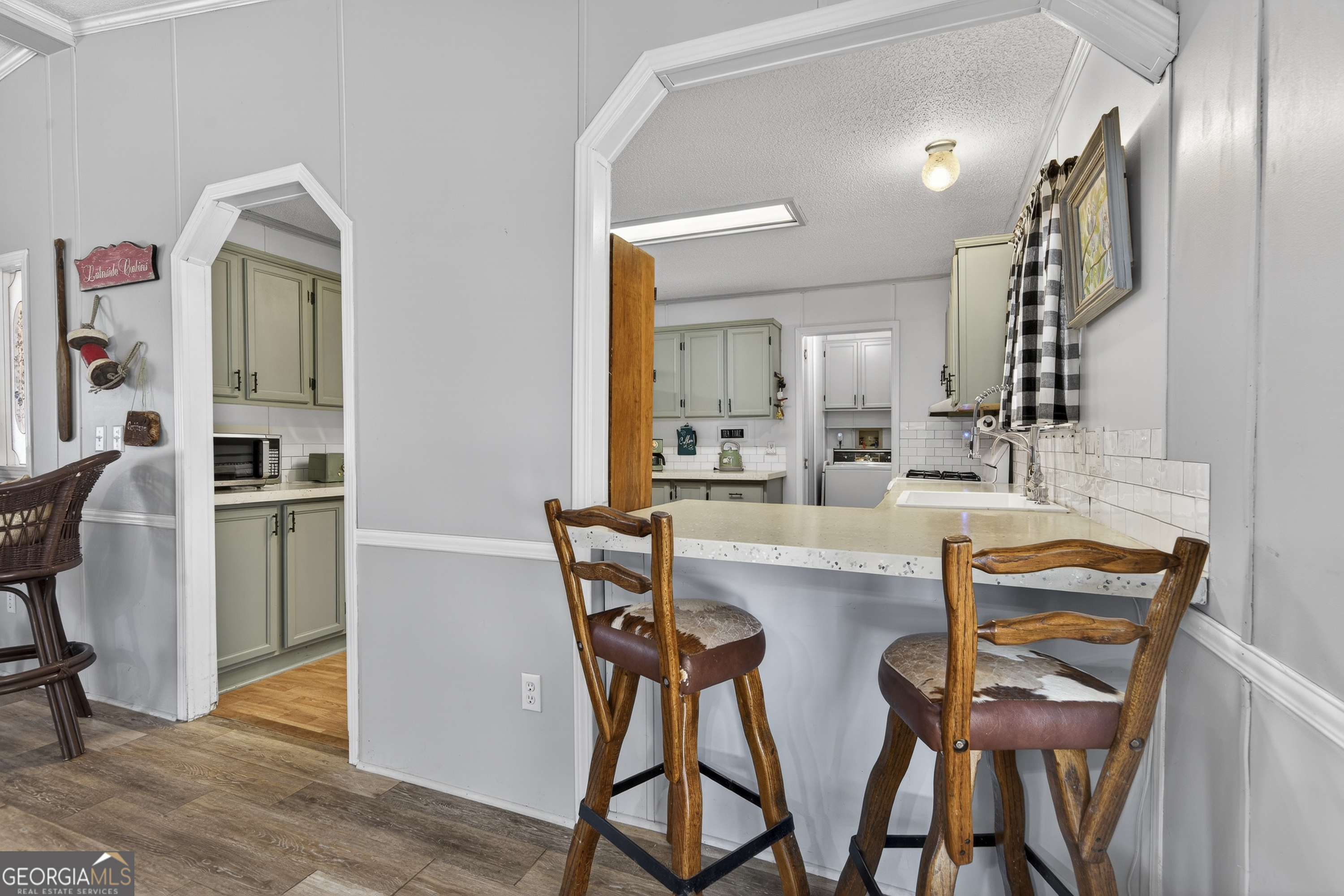 392 Hub Dent Road Northeast Milledgeville, GA 31061 - Photo 27 of 66 a dining area with furniture and a kitchen view