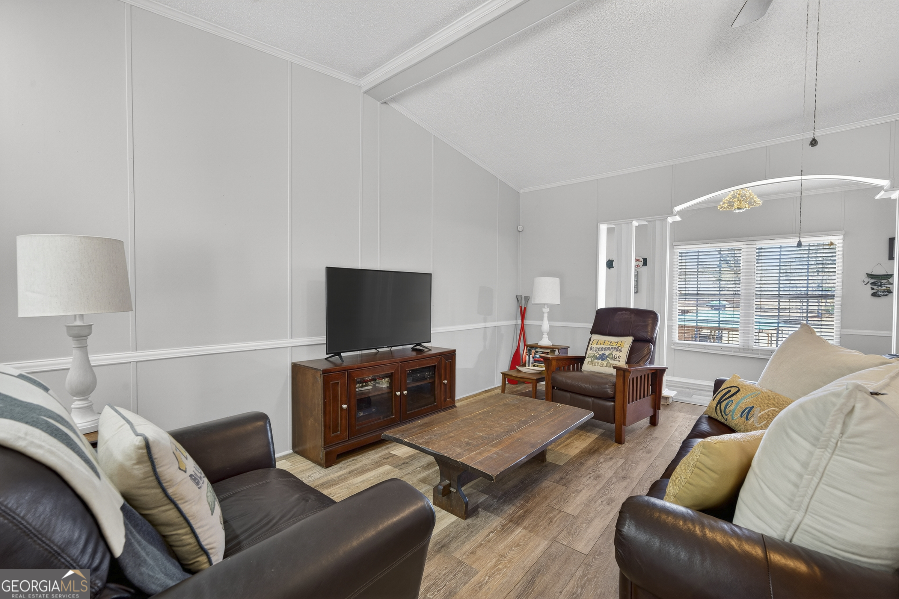 392 Hub Dent Road Northeast Milledgeville, GA 31061 - Photo 29 of 66 a living room with furniture and a flat screen tv