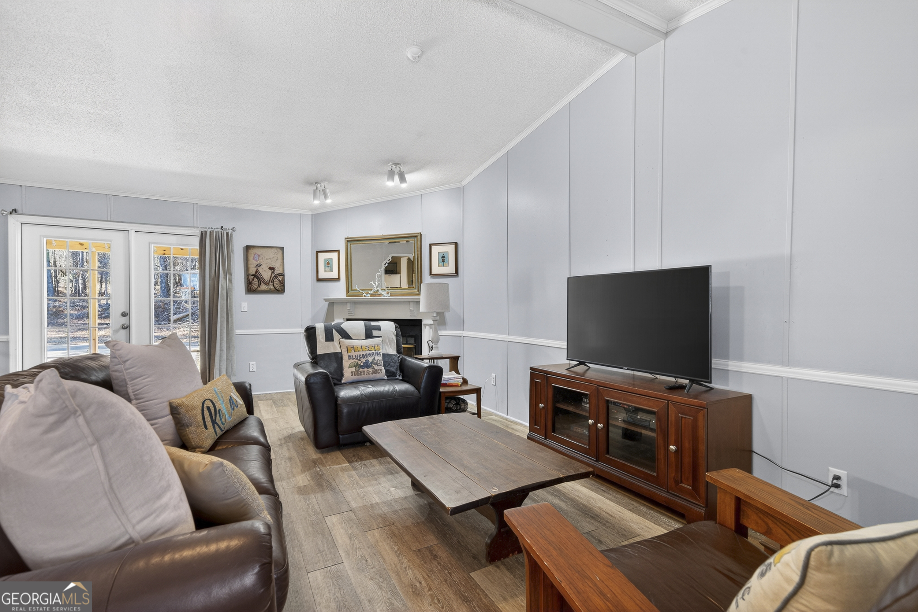 392 Hub Dent Road Northeast Milledgeville, GA 31061 - Photo 30 of 66 a living room with furniture and a flat screen tv