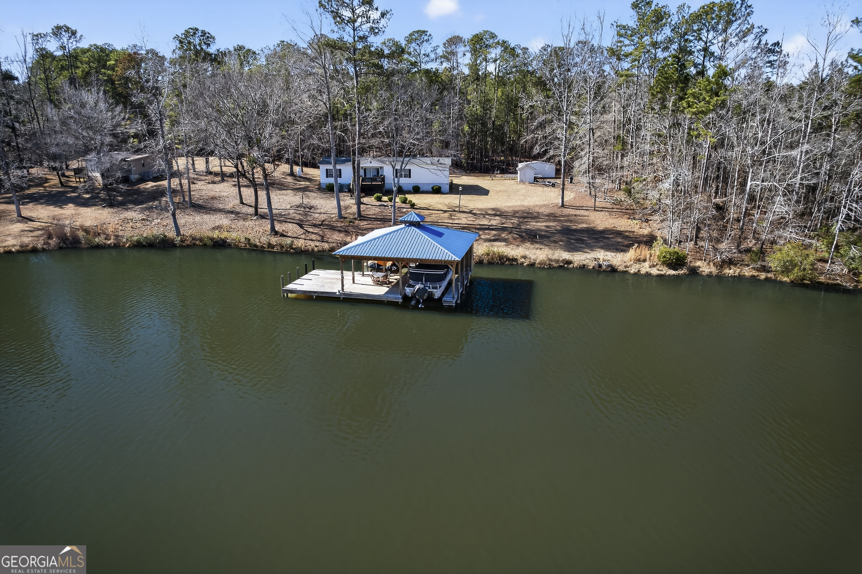 392 Hub Dent Road Northeast Milledgeville, GA 31061 - Photo 3 of 66 a view of a lake with houses