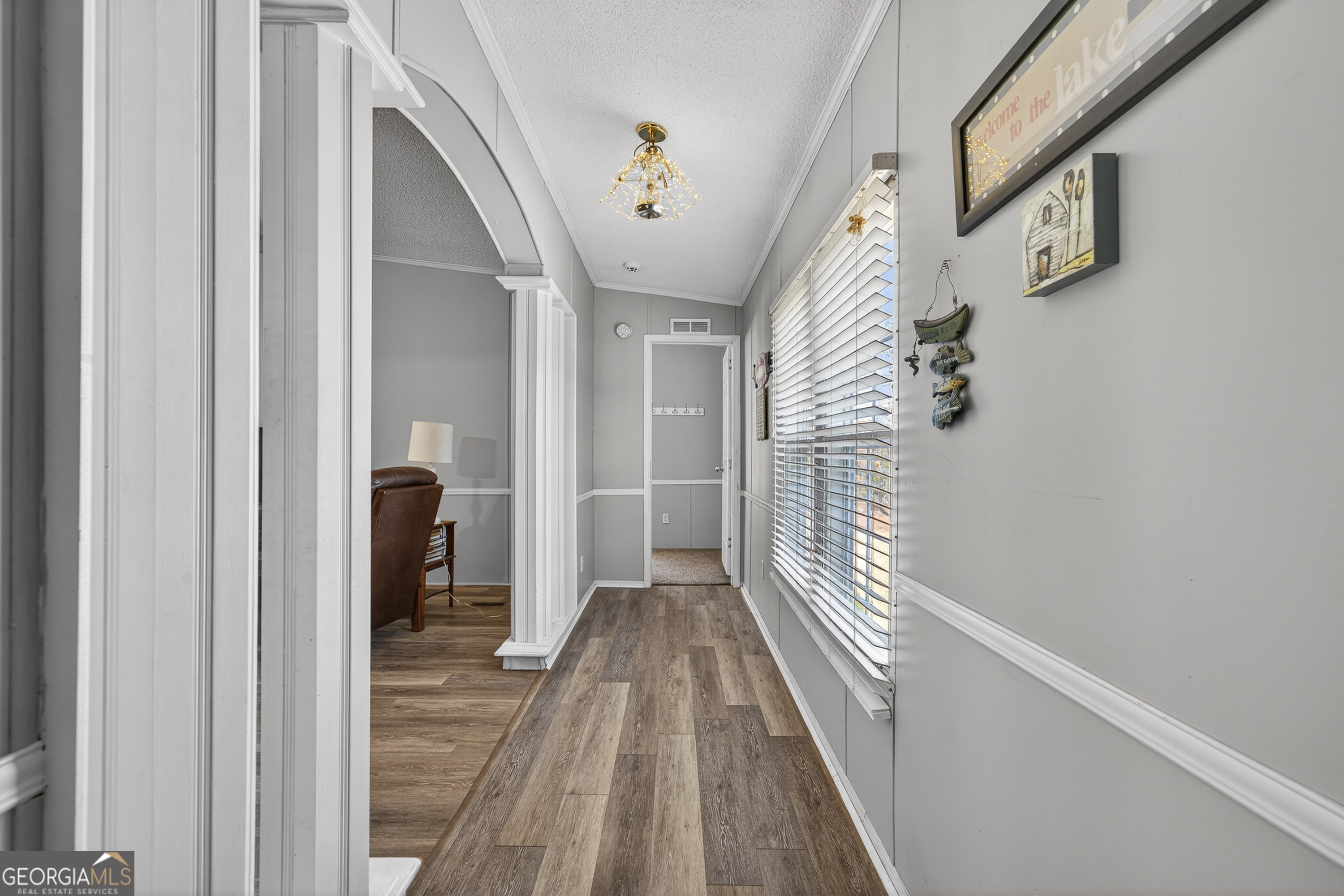 392 Hub Dent Road Northeast Milledgeville, GA 31061 - Photo 32 of 66 a view of a hallway with wooden floor and staircase
