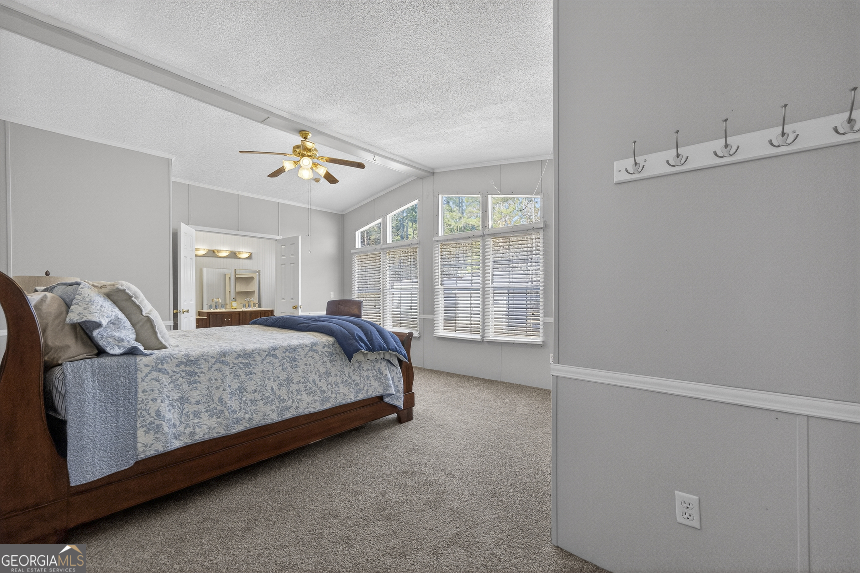 392 Hub Dent Road Northeast Milledgeville, GA 31061 - Photo 34 of 66 a spacious bedroom with a bed and a window