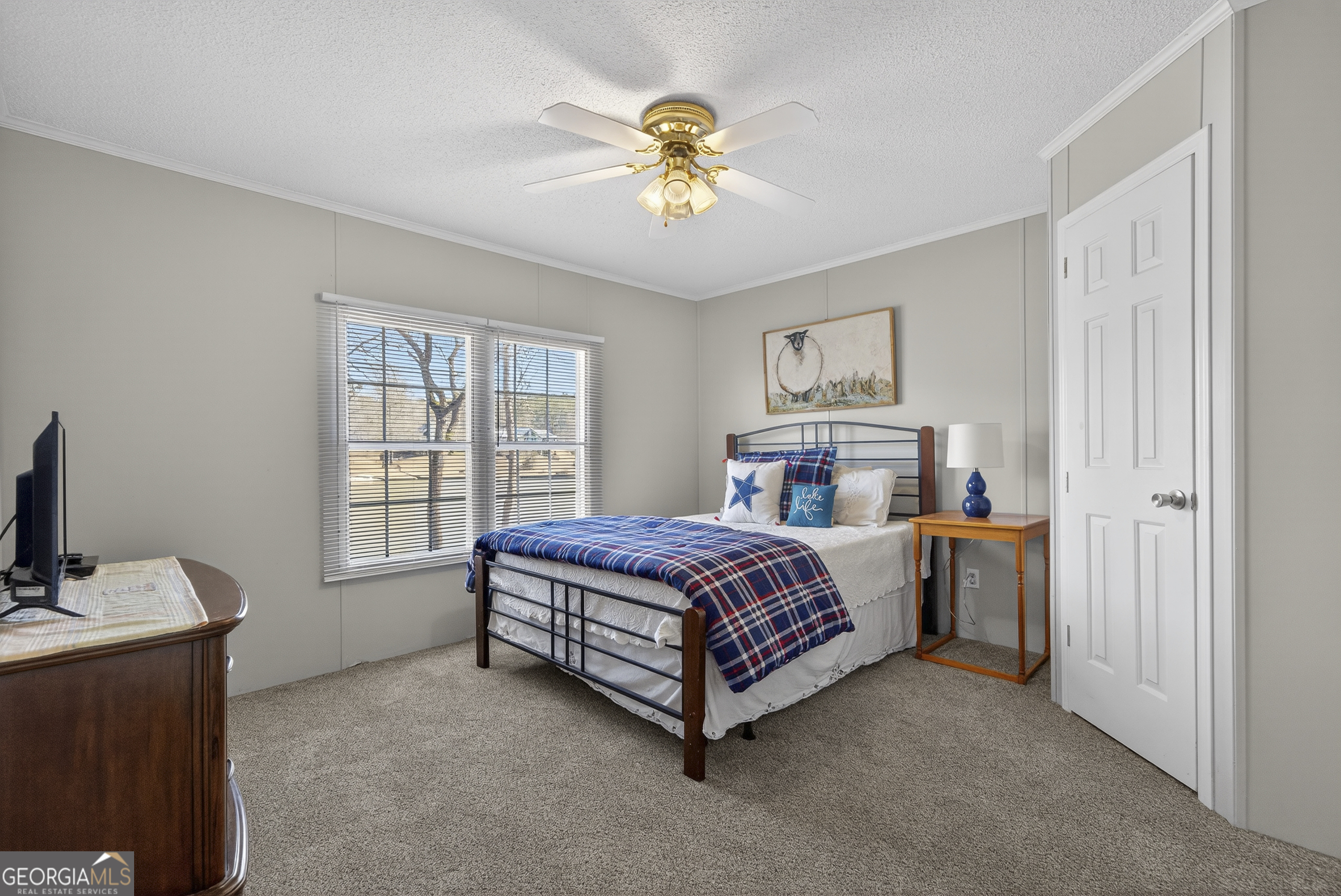 392 Hub Dent Road Northeast Milledgeville, GA 31061 - Photo 44 of 66 a bed room with a bed and a chandelier