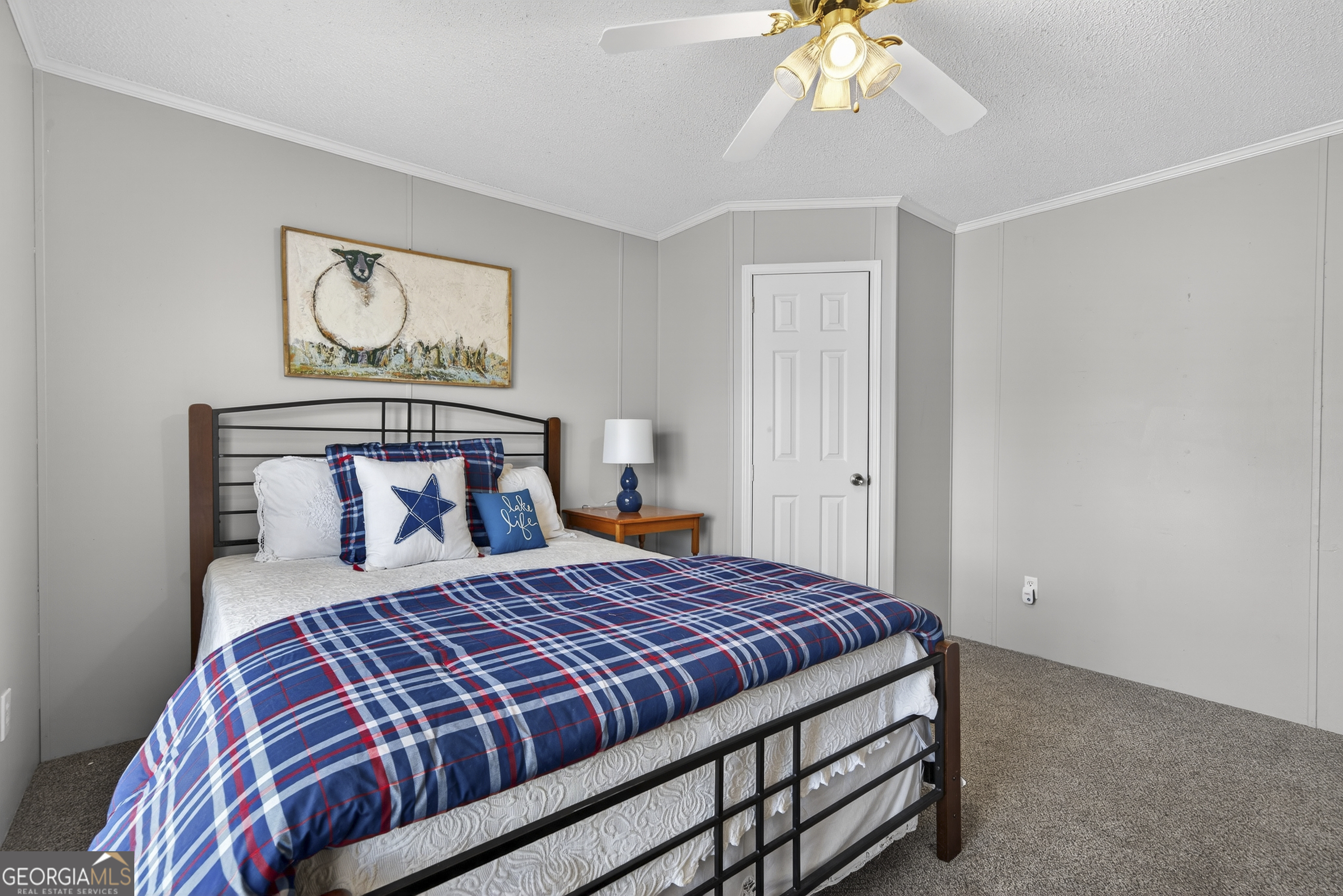 392 Hub Dent Road Northeast Milledgeville, GA 31061 - Photo 45 of 66 a bedroom with a bed and a chandelier