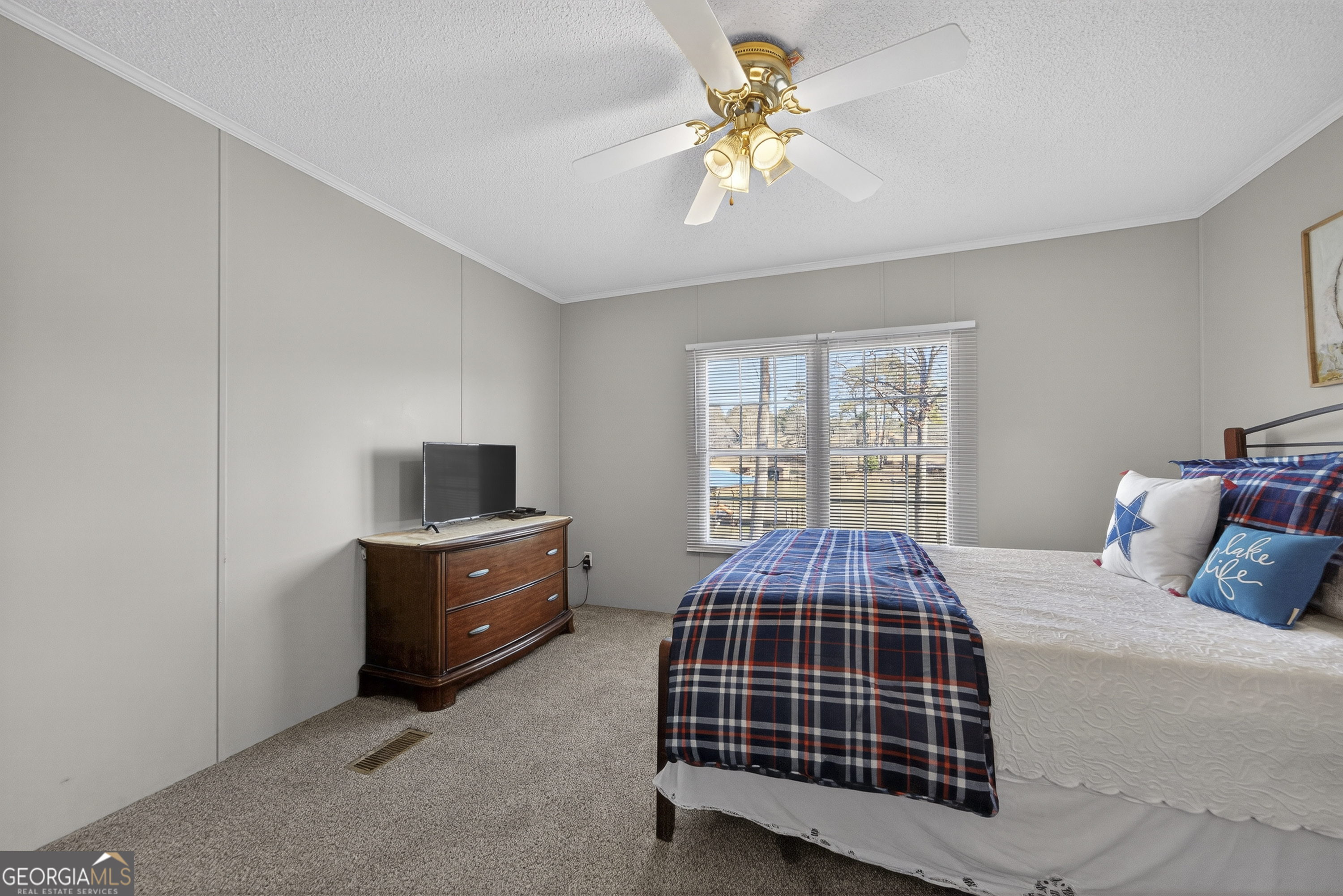 392 Hub Dent Road Northeast Milledgeville, GA 31061 - Photo 46 of 66 a bedroom with a bed and a chandelier