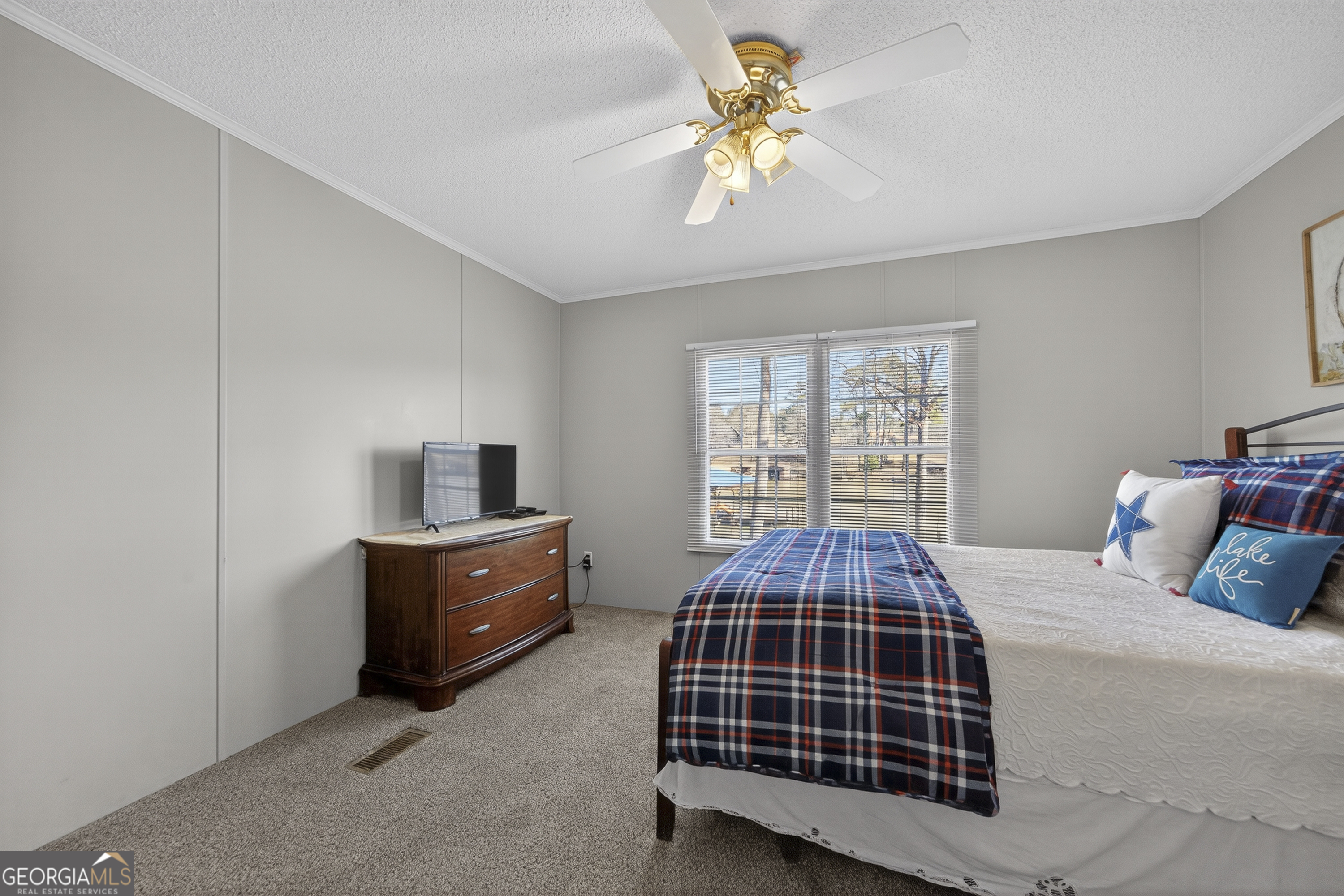 392 Hub Dent Road Northeast Milledgeville, GA 31061 - Photo 47 of 66 a bedroom with a bed and a chandelier