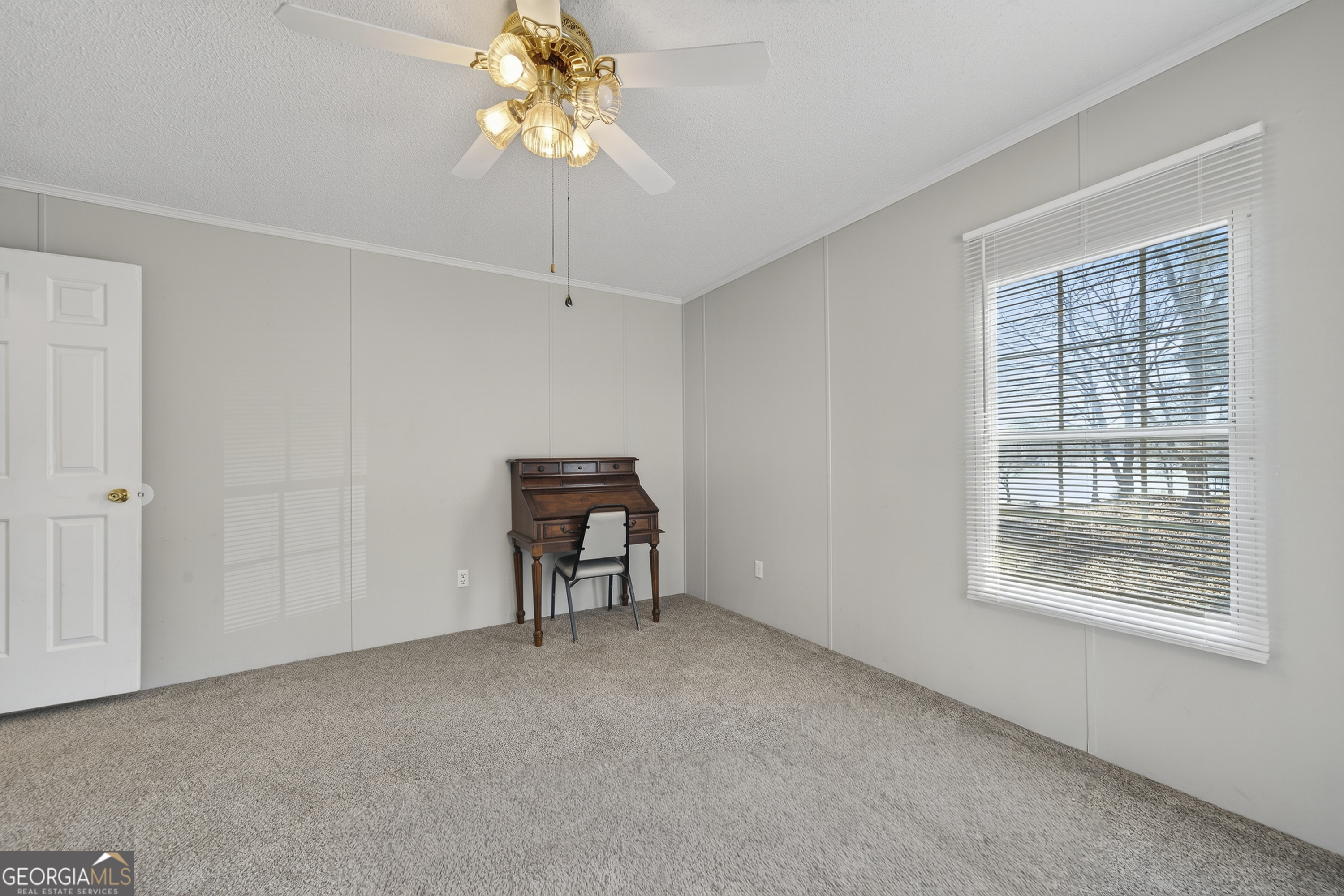 392 Hub Dent Road Northeast Milledgeville, GA 31061 - Photo 51 of 66 a view of a livingroom with a ceiling fan and window