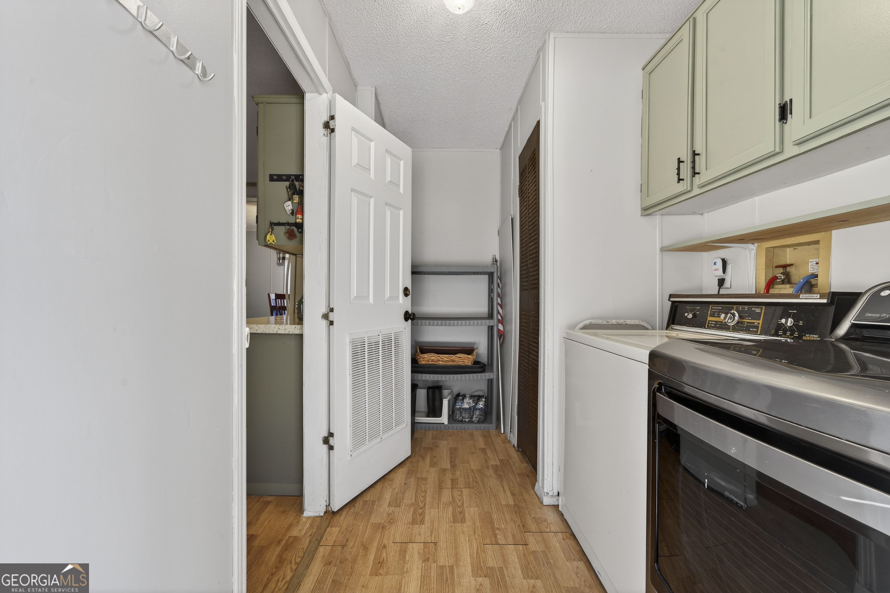392 Hub Dent Road Northeast Milledgeville, GA 31061 - Photo 53 of 66 a view of a kitchen with refrigerator and an oven