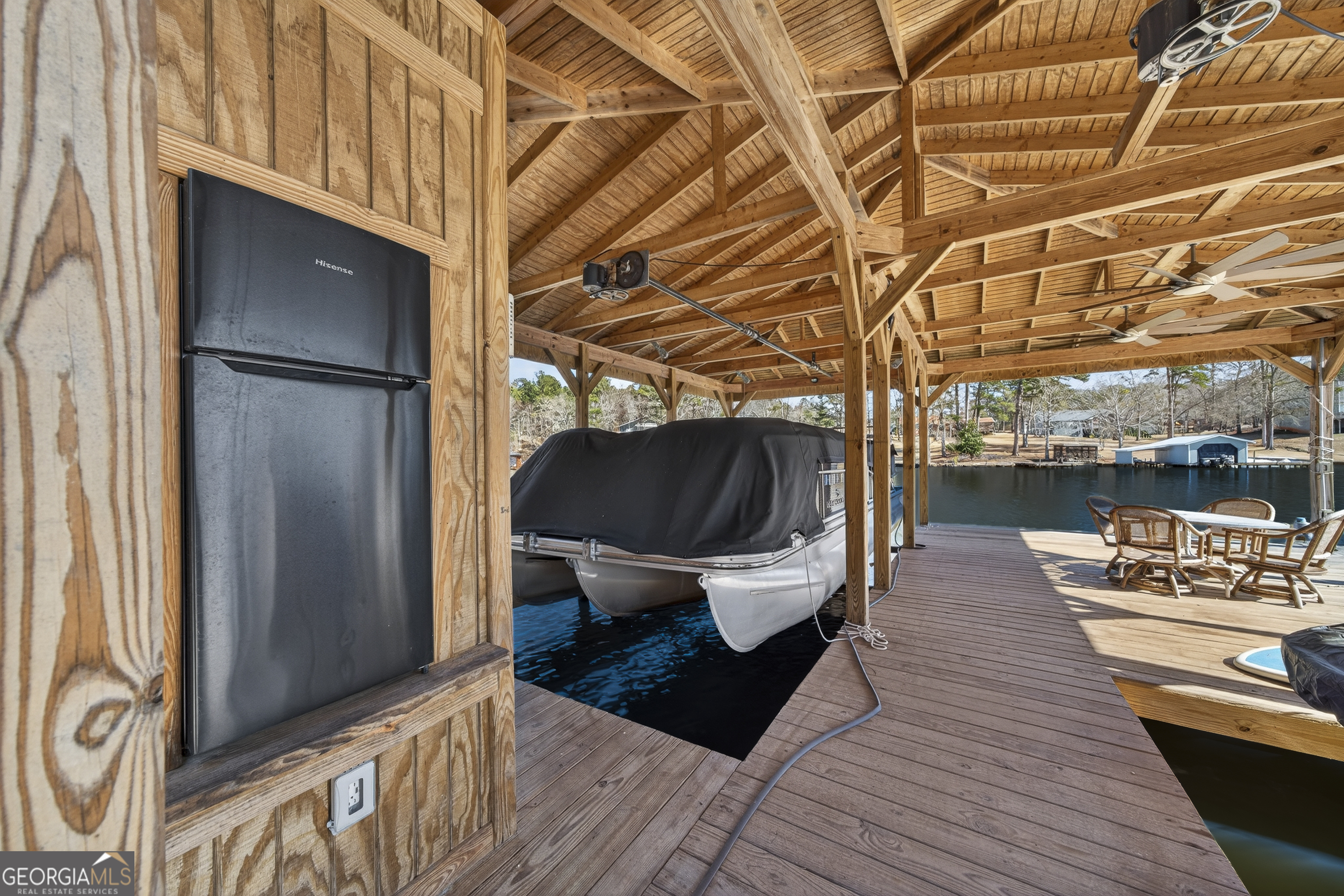 392 Hub Dent Road Northeast Milledgeville, GA 31061 - Photo 10 of 66 a view of a balcony with chairs and wooden floor