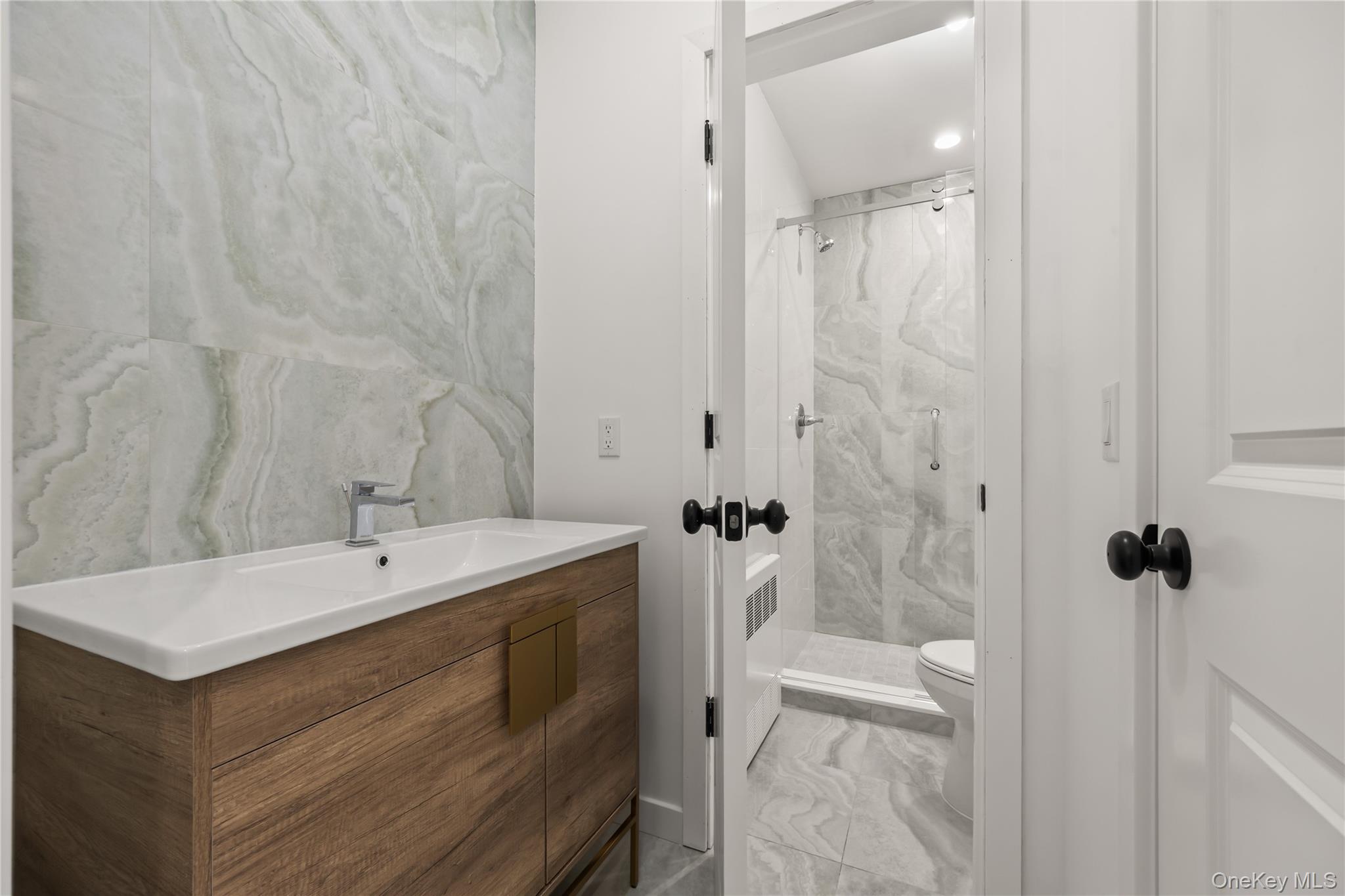 23 Singer Avenue, Unit 211 Spring Valley, NY 10977 - Photo 33 of 45 a bathroom with a sink a toilet and shower