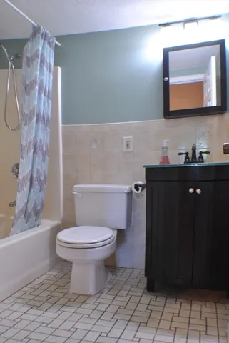 a bathroom with a toilet sink and shower