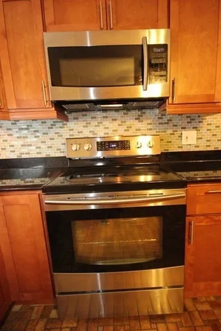 a stove top oven sitting inside of a kitchen