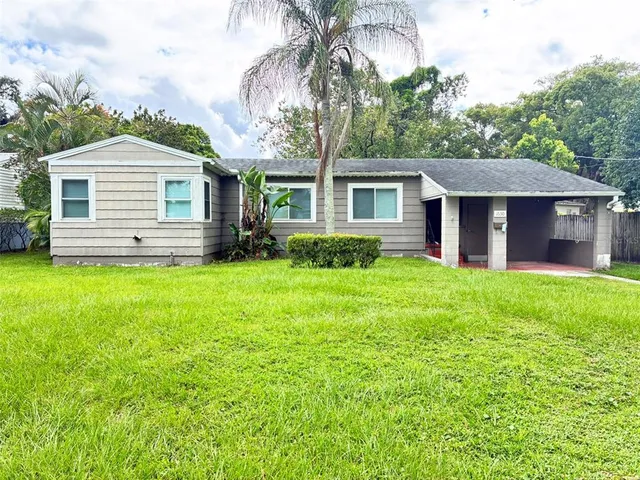 a front view of a house with yard and green space