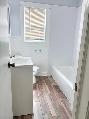 a bathroom with a bathtub and a window
