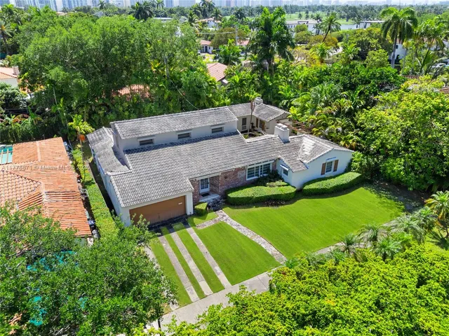 an aerial view of a house with a garden and swimming pool