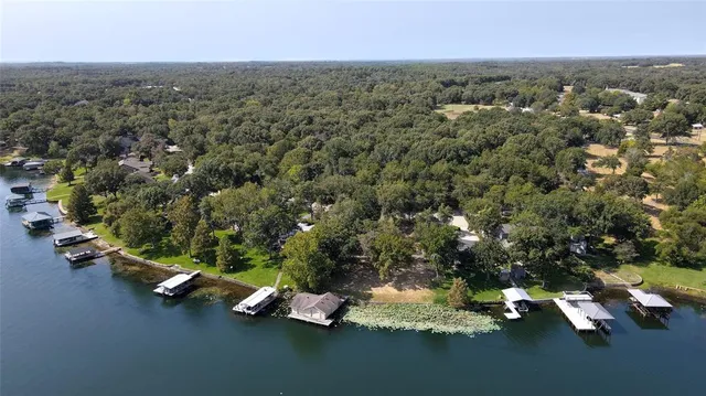 an aerial view of a houses with yard