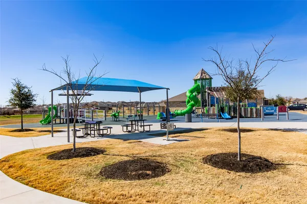 a childrens park with lots of swings and slides