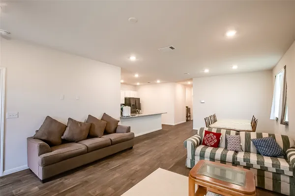 a living room with furniture and wooden floor