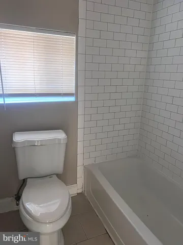 a bathroom with a toilet and a bathtub