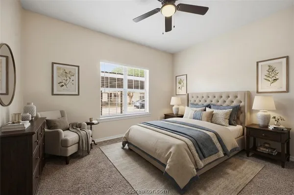 a bedroom with bed couch and window