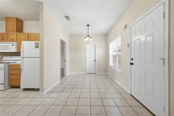 a view of a hallway with closet and utility room