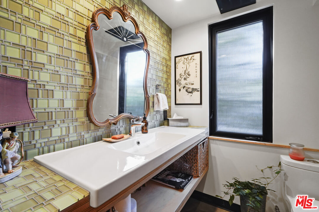 26335 Lockwood Road Malibu, CA 90265 - Photo 12 of 39 a bathroom with a sink mirror and vanity